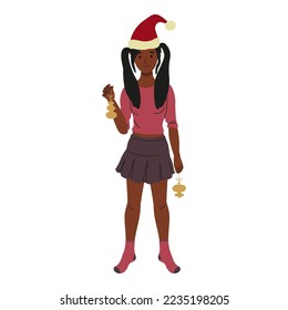 Cute black girl in Santa's hat with Christmas toys in hands. Isolated on white background. New Year and Christmas celebration
