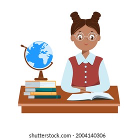 A cute black schoolgirl with glasses sits at her desk. Books and a globe are on the table. The book is open. Hands are folded. Isolated on a white background. Flat style. Concept. Vector illustration