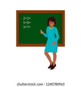 A cute black teacher smiling standing in front of chalkboard with copy space for your text. Traditional education concept.