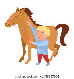 Cute blonde hair boy give fresh red carrot to horse