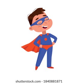 Cute Boy in Blue Superhero Costume and Red Cape, Adorable Kid Character Standing in Superhero Pose with Hands on his Waist Cartoon Style Vector Illustration