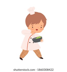 Cute Boy with Bowl, Cute Little Chef Character in Uniform Cooking in the Kitchen Cartoon Style Vector Illustration