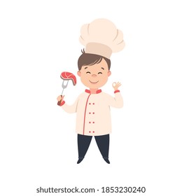 Cute Boy Chef Cooking Meat Steak, Kid in Chef Uniform Cooking in Kitchen Cartoon Style Vector Illustration