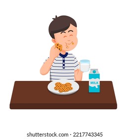 a cute boy eats his cookies while holding a glass of milk