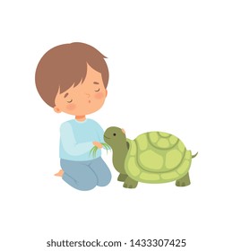 Cute Boy Feeding Turtle with Grass, Kid Interacting with Animal in Contact Zoo Cartoon Vector Illustration