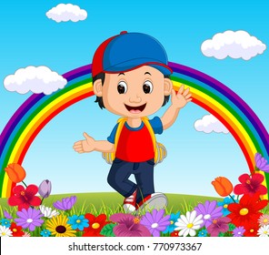 Cute boy in a flower garden with rainbow