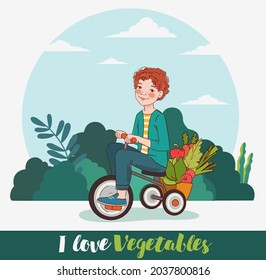Cute boy with fresh vegetables rides on bicycle in the garden. Summer time