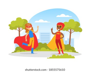 Cute Boy and Girl Dressed in Superhero Costumes Playing Outdoors, Happy Kids Having Fun in Park Cartoon Vector Illustration