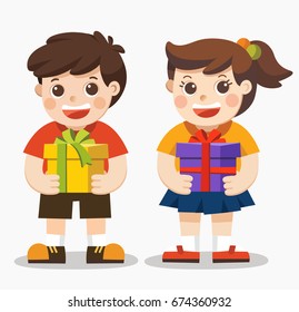 Cute boy and girl holding big ribbon bow wrapped gift box in front of them in arms.