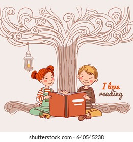 Cute boy and girl reading a book under the tree