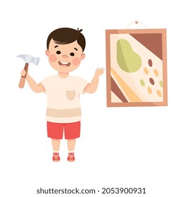 Cute Boy with Hammer Doing Housework and Housekeeping Hanging Picture on the Wall Vector Illustration