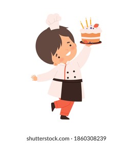 Cute Boy Holding Birthday Cake, Cute Little Chef Character in Uniform Cooking in the Kitchen Cartoon Style Vector Illustration