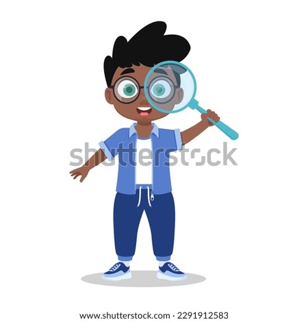 Cute boy looks through a magnifying glass, the child explores the world