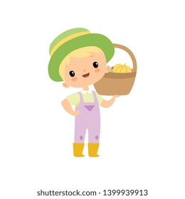 Cute Boy in Overalls, Rubber Boots and Hat with Basket of Fresh Vegetables, Young Farmer Cartoon Character Harvesting Vector Illustration