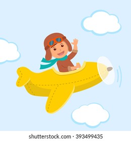 Cute boy pilot flies on a yellow plane in the sky. Air adventure