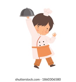 Cute Boy with Platter, Cute Little Chef Character in Uniform Cooking in the Kitchen Cartoon Style Vector Illustration