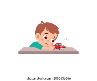 cute boy play toy car alone and feel sad