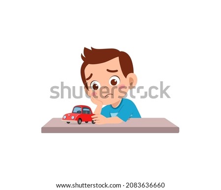 cute boy play toy car alone and feel sad