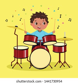 Cute boy playing the drum on yellow background