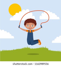 cute boy playing jumping rope in the park