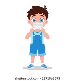 Cute boy in a protective mask points his fingers at the mask