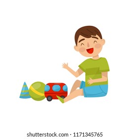 Cute boy sitting on the floor playing with toys, kids activity, daily routine vector Illustration on a white background