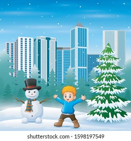 Cute a boy and snowman in snowy city park background
