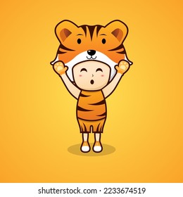 Cute boy wearing tiger costume and raising hands