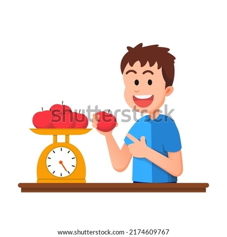 a cute boy is weighing some apples