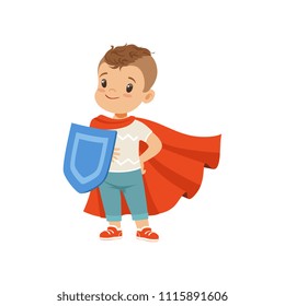 Cute brave little boy character in red cape standing with shield vector Illustration on a white background