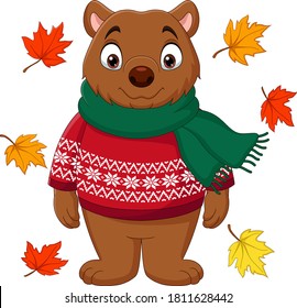 Cute brown bear in a sweater and scarf with autumn leaves