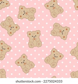 Cute brown teddy bear on a pink polka dot texture seamless background. Kids fabric and textile vector pattern.