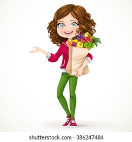 Cute brunette girl with curly hair holding a paper bag with fruit and vegetables standing on a white background