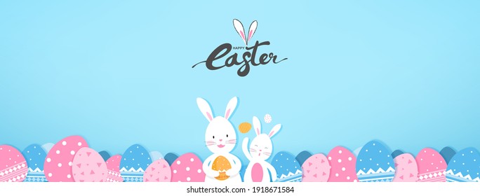 Cute bunnies and colorful Easter eggs on light blue banner background 
