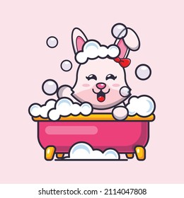 Cute bunny cartoon mascot illustration taking bubble bath in bathtub.