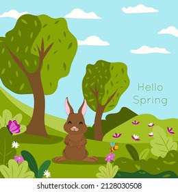 A cute bunny in a flower field rejoices at the arrival of spring