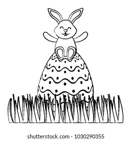 cute bunny sitting in easter egg on grass