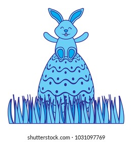 cute bunny sitting in easter egg on grass