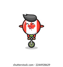The cute canada flag badge character is riding a circus bike , cute style design for t shirt, sticker, logo element