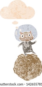 cute cartoon astronaut cat with thought bubble in grunge distressed retro textured style