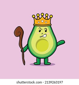 Cute cartoon avocado mascot as wise king with golden crown and wooden stick