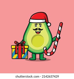 cute cartoon avocado santa clause character is bringing candy cane and boxes christmas illustration