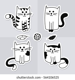 Cute cartoon black and white cats or kittens with cat toys. Set of four wall stickers or decals or decoration