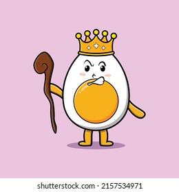 Cute cartoon boiled egg mascot as wise king with golden crown and wooden stick