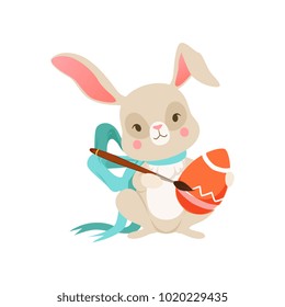 Cute cartoon bunny with blue bow with egg, funny rabbit character, Happy Easter concept cartoon vector Illustration