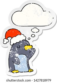 cute cartoon christmas penguin with thought bubble as a distressed worn sticker