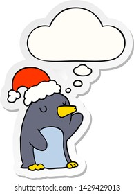 cute cartoon christmas penguin with thought bubble as a printed sticker