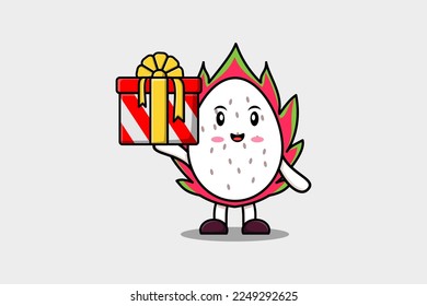 Cute cartoon Dragon fruit character holding gift box in vector icon illustration