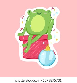 Cute cartoon frog with confetti sitting on a red gift box. Kids sticker, poster. Hand drawn doodle character. Vector illustration on an isolated pink background.