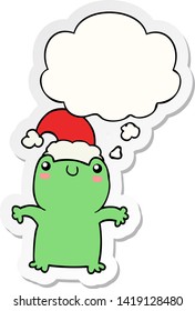 cute cartoon frog wearing christmas hat with thought bubble as a printed sticker